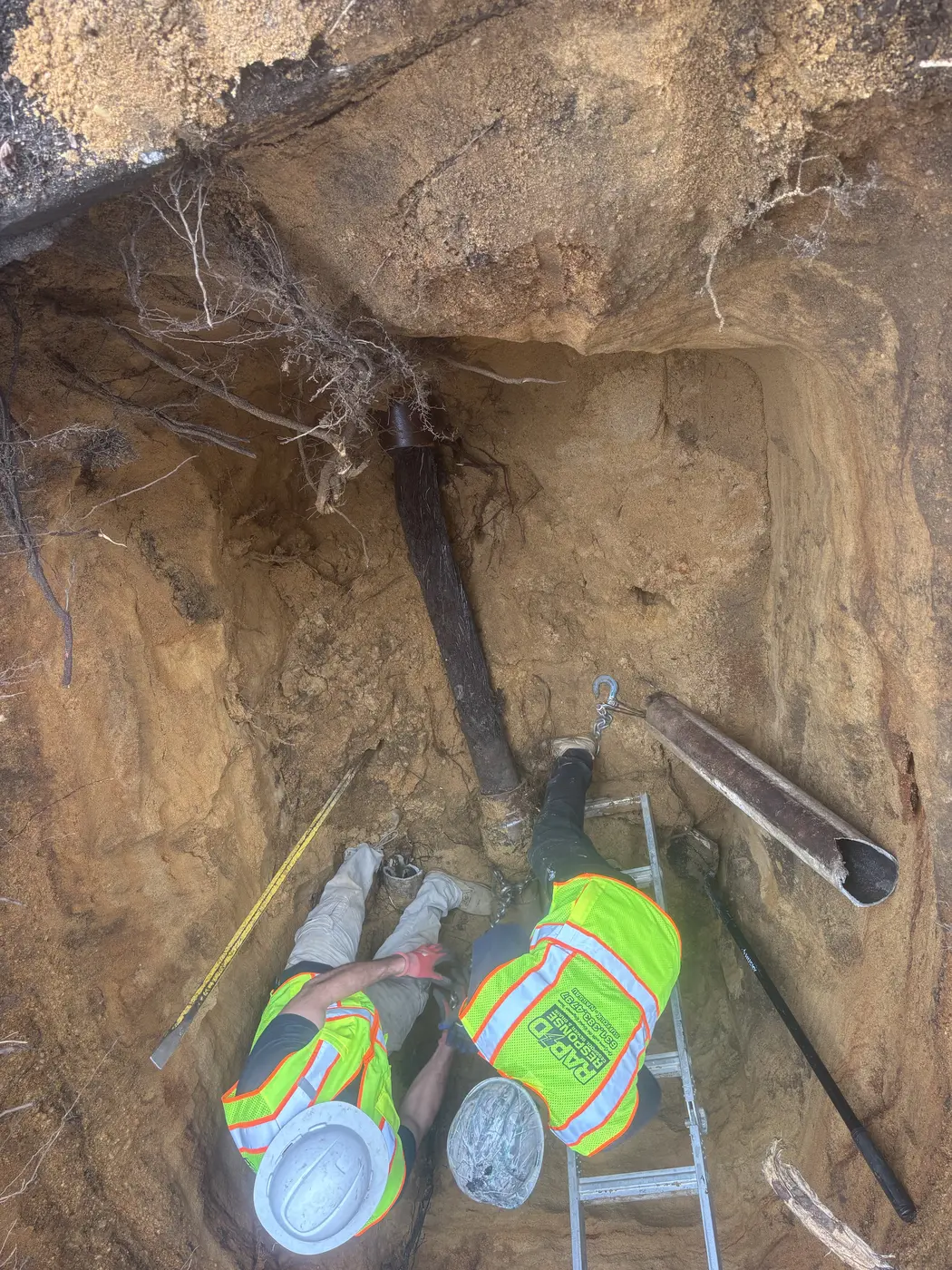 Rapid Response workers repairing underground cesspool pipe on Long Island
