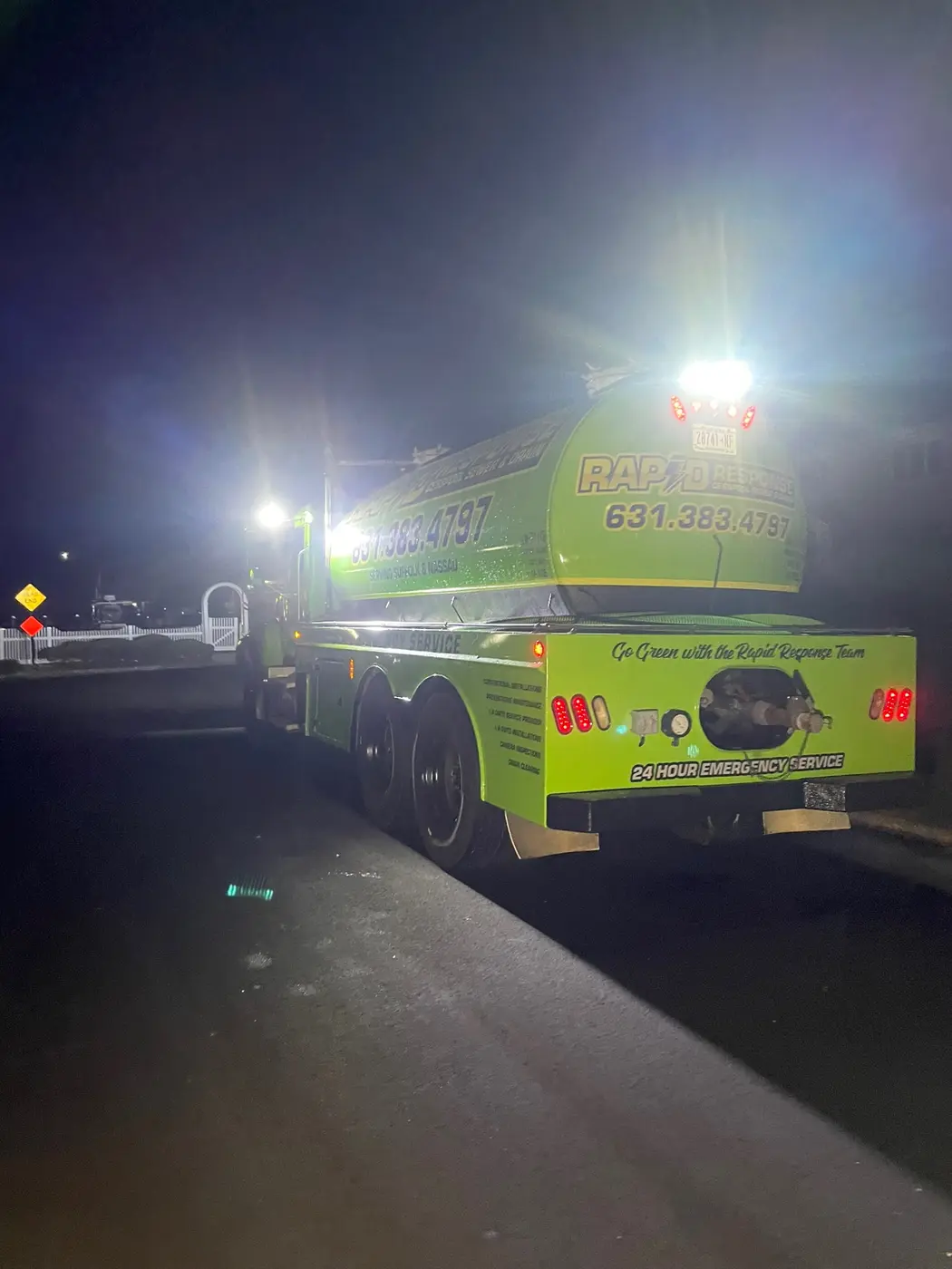 Rapid Response vacuum tanker at night — emergency cesspool service Long Island